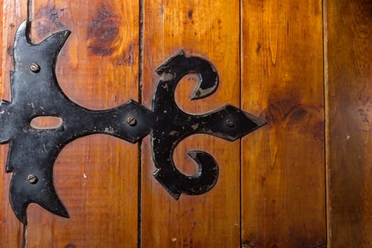 black metal handmade hinge on wooden chest