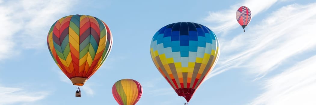 Multi colored hot air balloons on blue sky
