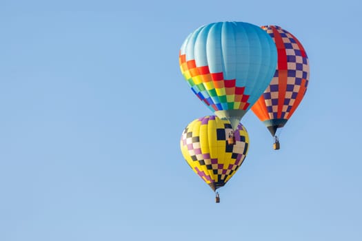 Multi colored hot air balloons on blue sky