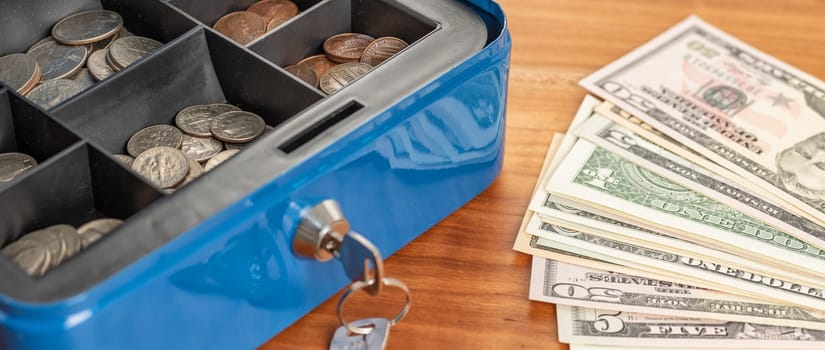 A cash box with bills and coins
