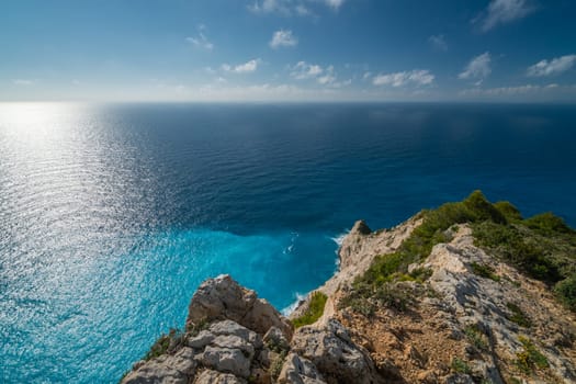 Cliffs near crystal clear torquoise waters near Shipwreck Cove in summer on Zante Island, Greece