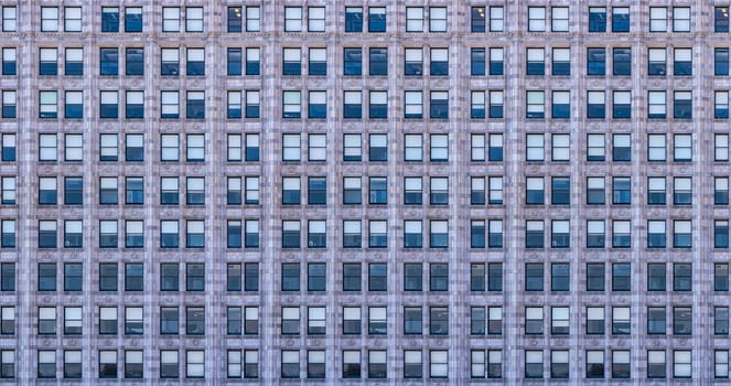Urban abstract - window facade of business center office building with reflections and colours.