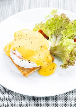 gourmet Salmon egg benedict in white plate