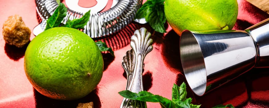 Fresh mojito cocktail and bar utensils.Mojito cocktail with mint and lime