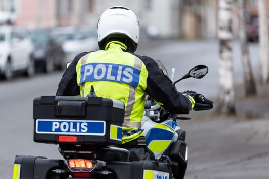 Swedish Motorcycle Police Officer from behind.
