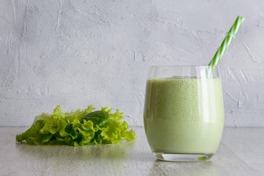 Smoothies from Greek yogurt with herbs on a gray background