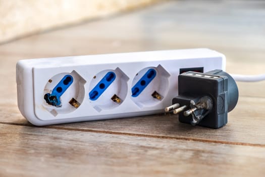 burnt power strip melted for electrocution danger copy space .
