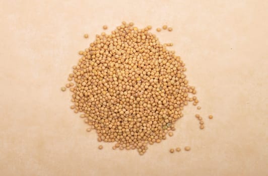 Mustard seeds on brown background