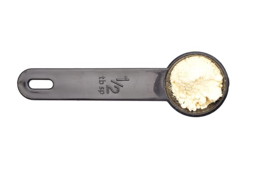 Lupin flour in measuring spoon on white background