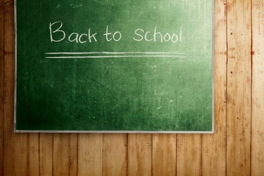 Chalkboard with Back to School message on wooden wall. Back to School concept