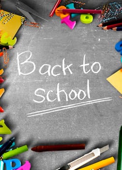 School supplies and stationery on blackboard with Back to School text. Back to School concept