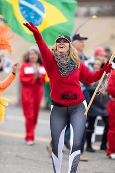 St. Louis, Missouri, USA - March 2, 2019: Bud Light Grand Parade, People of Brazilian ancestry, throwing beads and dancing during the parade