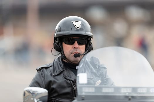 St. Louis, Missouri, USA - March 2, 2019: Bud Light Grand Parade, Police officer from the St. Louis P.D. Motor Squad riding down 7th Street
