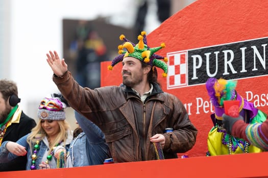 St. Louis, Missouri, USA - March 2, 2019: Bud Light Grand Parade, Man wearing a joker hat, on a float throwing beads to spectators