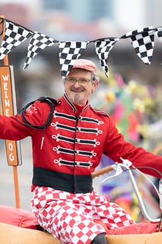 St. Louis, Missouri, USA - March 2, 2019: Bud Light Grand Parade, Man riding a bicycle in shape of a hotdog, down 7ths street during the parade