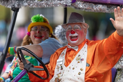 Wilmington, North Carolina, USA - April 6, 2019: The North Carolina.Azalea Festival, Port City Silly Clowns, smiling and waving at people during the parade