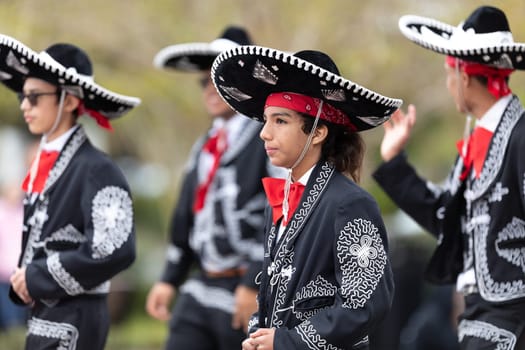 Wilmington, North Carolina, USA - April 6, 2019: The North Carolina.Azalea Festival, People of diferent cultures wearing traditional clothing going down 3rd street during the parade