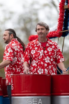 Wilmington, North Carolina, USA - April 6, 2019: The North Carolina.Azalea Festival,  Members of the Sea Pans playing steel drums during the parade