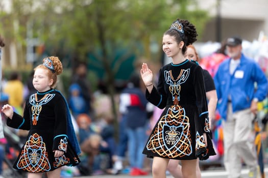 Wilmington, North Carolina, USA - April 6, 2019: The North Carolina.Azalea Festival, People of diferent cultures wearing traditional clothing going down 3rd street during the parade