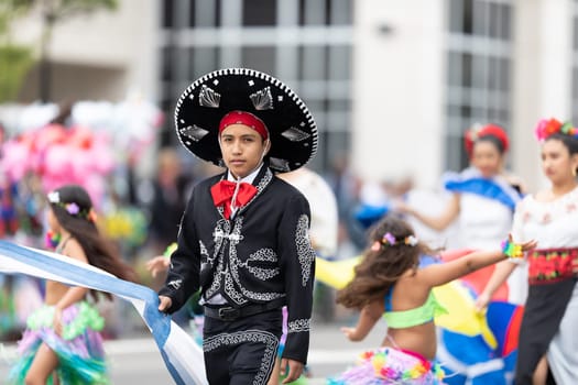 Wilmington, North Carolina, USA - April 6, 2019: The North Carolina.Azalea Festival, People of diferent cultures wearing traditional clothing going down 3rd street during the parade