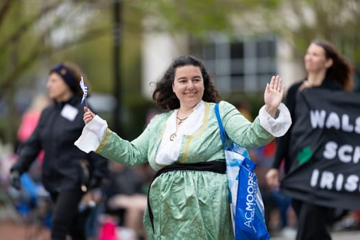 Wilmington, North Carolina, USA - April 6, 2019: The North Carolina.Azalea Festival, People of diferent cultures wearing traditional clothing going down 3rd street during the parade