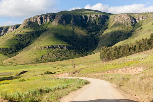 Rural dirt road route along scenic summer mountain landscape