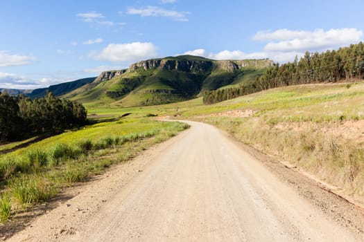 Rural dirt road route along scenic summer mountain landscape