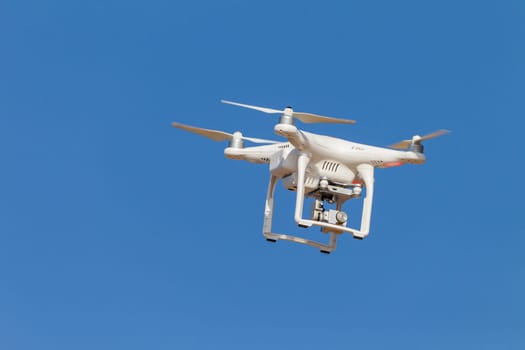 Drone aircraft remote video camera in blue sky closeup.