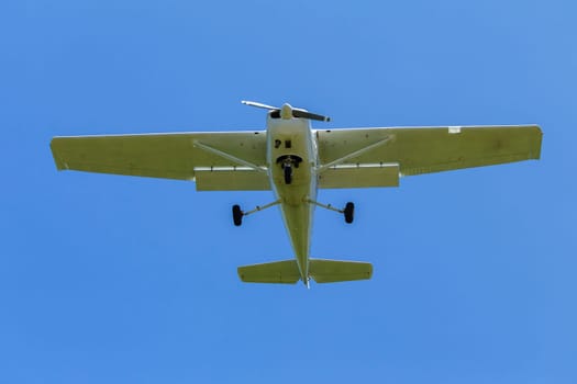 Plane light aircraft single prop flying overhead landing approach.
