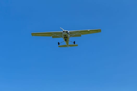 Plane light aircraft single prop flying overhead landing approach.