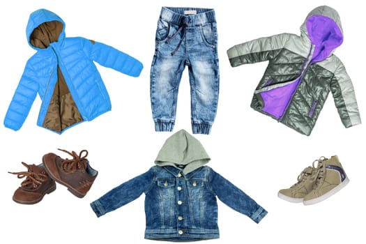 Collage set of children clothes. Denim jeans or pants, jeans jacket, two pair shoes ,and two rain jackets for child boy isolated on a white background. Concept spring autumn and summer clothes.