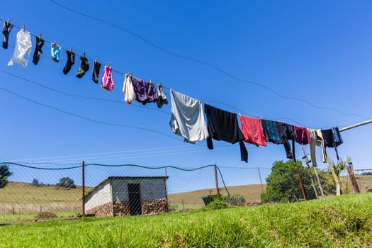 Farm washing clothes drying lines rural lifestyle landscape blue sky outdoors..