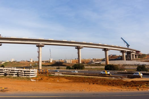 New Road highway expansion construction industrial building of overhead ramps concrete columns to traffic vehicle junction.