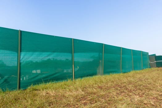 Construction building site boundary green nylon blinds.