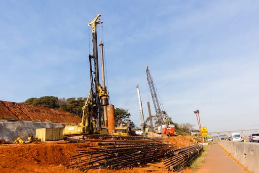 New Road highway expansion construction industrial building of overhead ramps concrete columns to traffic vehicle junction.