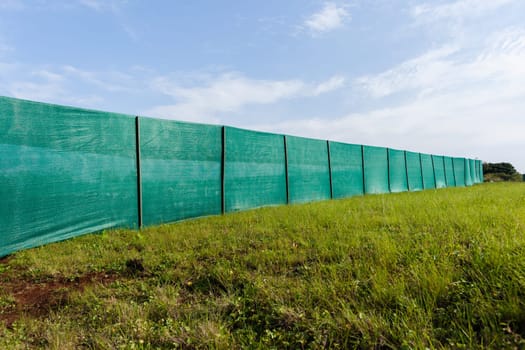 Construction building site boundary green nylon blinds.