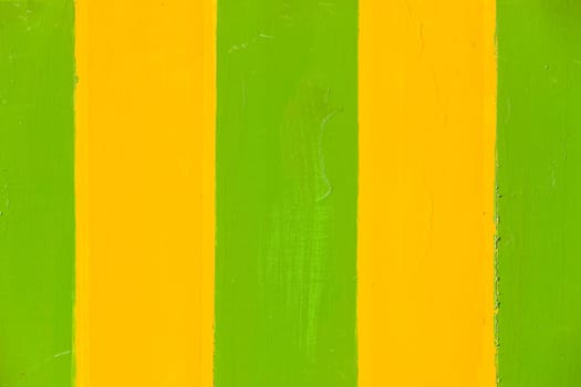 Paint stripes green yellow wet textures closeup background sign board panel.