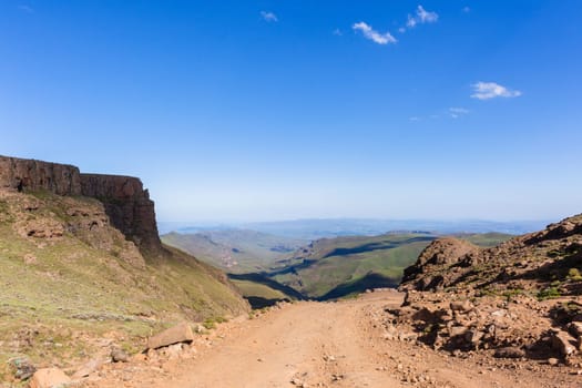 Mountain high dirt road pass from river valley up or down by four wheel vehicle  summer landscape