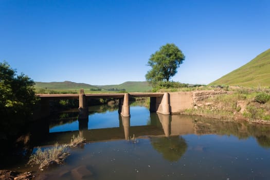 Small river bridge road scenic scenic rural mountain terrain summer landscape.