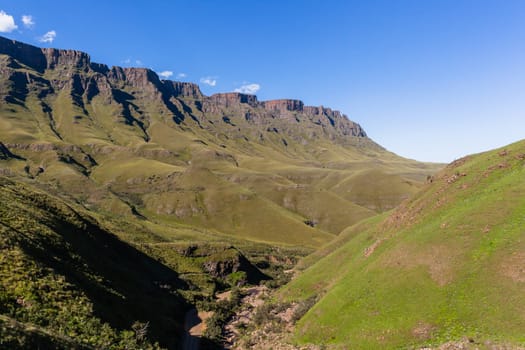 Mountains valley river rocky cliffs rural countryside scenic summer landscape.