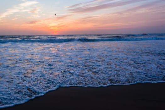 Beach ocean waves shoreline sunrise water sand color reflections horizon  skyline landscape