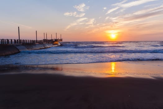 Beach ocean waves shoreline sunrise water sand color reflections horizon  skyline landscape