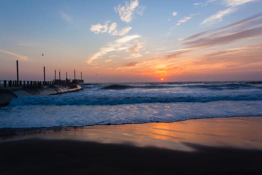 Beach ocean waves shoreline sunrise water sand color reflections horizon  skyline landscape