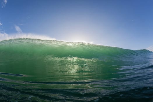 Wave ocean swimming encounter wall of water crashing breaking beauty nature power back-light closeup photo. .