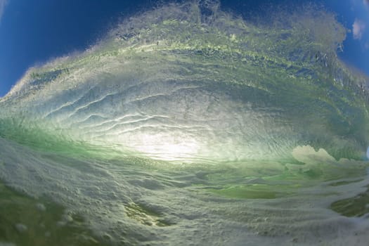 Wave ocean swimming encounter wall of water crashing breaking beauty nature power back-light closeup photo. .