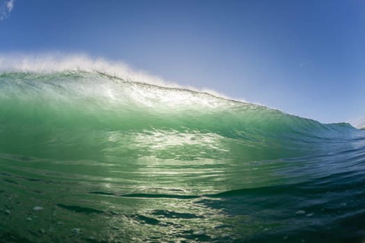 Wave ocean swimming encounter wall of water crashing breaking beauty nature power back-light closeup photo. .