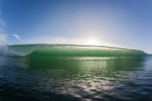 Wave ocean swimming encounter wall of water crashing breaking beauty nature power back-light closeup photo. .