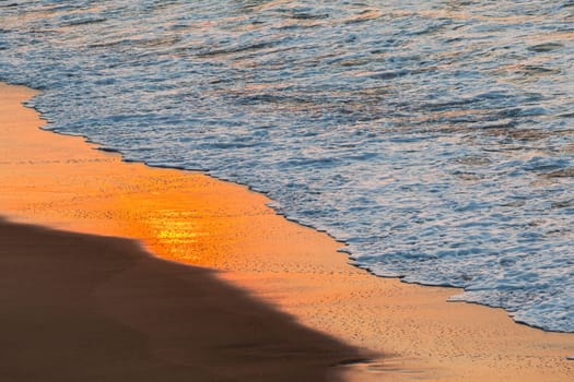Beach sands waterline shoreline sunrise color mirror sunlight reflections of ocean water nature