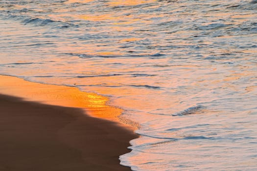 Beach sands waterline shoreline sunrise color mirror sunlight reflections of ocean water nature