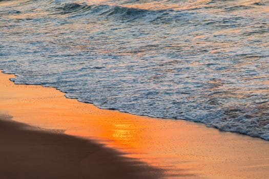 Beach sands waterline shoreline sunrise color mirror sunlight reflections of ocean water nature